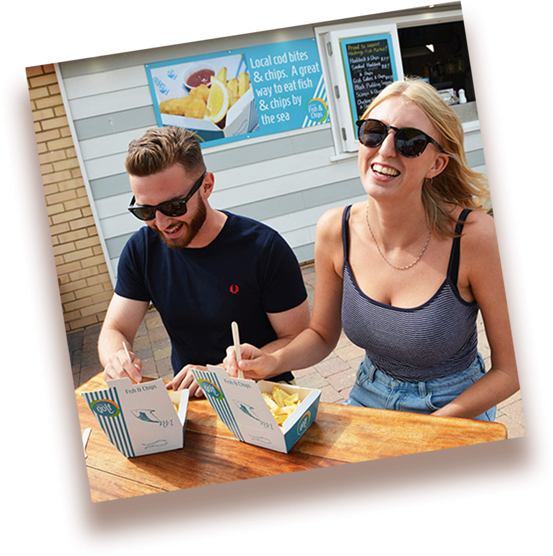 young couple enjoying fish and chips in hastings